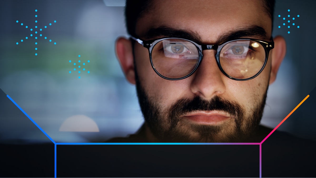 Businessperson’s face as they view Cisco 360 benefits on a computer screen that’s reflected on their glasses.