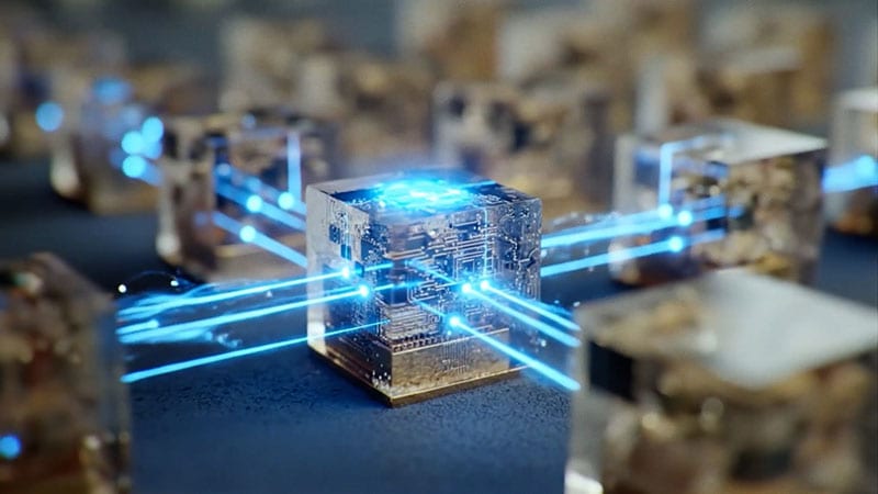 Des cubes translucides lumineux avec des circuits internes reliés par des faisceaux lumineux bleus.